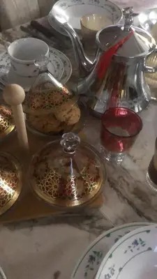 a table topped with plates and a tea pot and dishes at khamsin home in Fès