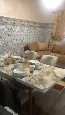a table with plates on it in a living room at khamsin home in Fès