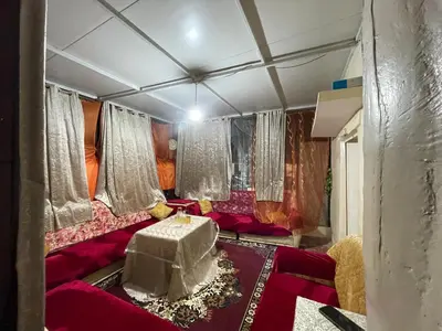 a living room with a red couch and a table at House medina in Fès