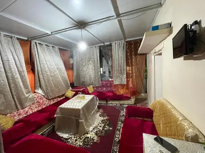 a living room with a couch and a table at House medina in Fès