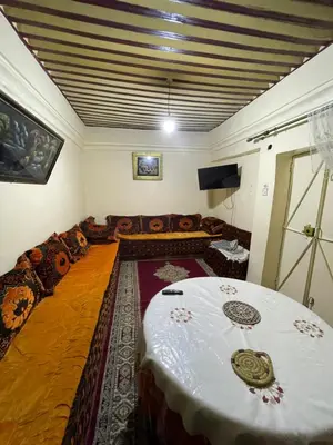 a living room with a table and a couch at Dar charfa in Fès