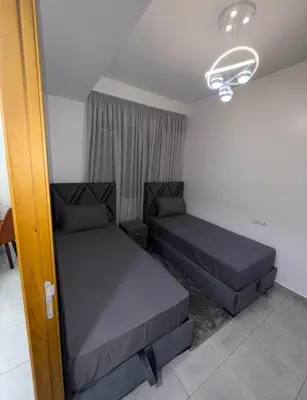 a bedroom with two beds in a room at Alyassamine in Taza