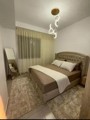 a bedroom with a bed and a chandelier at Alyassamine in Taza