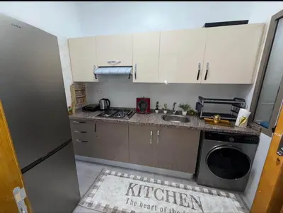a kitchen with a sink and a washing machine at Alyassamine Taza in Settat