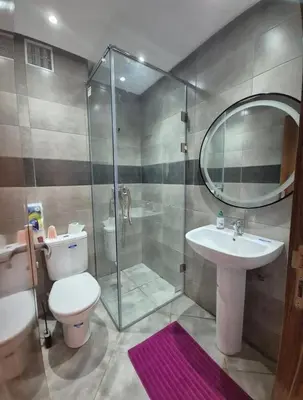 a bathroom with a shower and a toilet and a sink at Alyassamine Taza in Settat