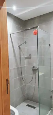 a shower with a glass door in a bathroom at Idrissi appartement in Fès