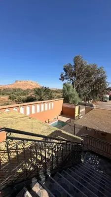 a view of a building with a grass roof at Apartment with Pool & Kasbah View in Aït Ben Haddou