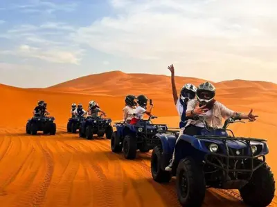 a group of people riding on atvs in the desert at Africa Berber Camp in Merzouga