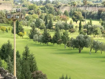 a view of a park with trees and a pole at Riad Golf Stinia 1 in Meknès