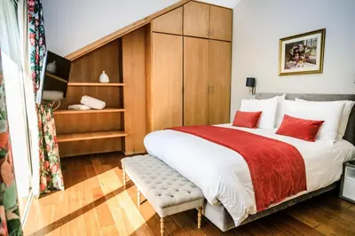a bedroom with a large bed with red pillows at Le Palais des Cerisiers in Azrou
