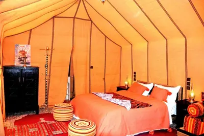a bedroom with a bed in a tent at Sahara Luxury Tents in Merzouga