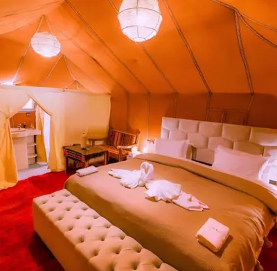 a bedroom with a bed in a tent at Comfort Luxury Camp in Merzouga