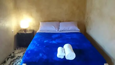 a bed with two white socks sitting on it at Camping Bassou in Nkob