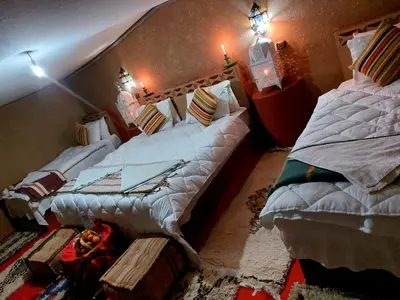 two large beds in a room with at Desert Bivouac Mhamid in Mhamid