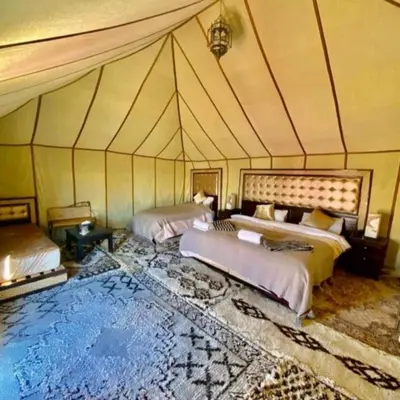 a room with two beds in a tent at Sunset Camp Merzouga in Merzouga