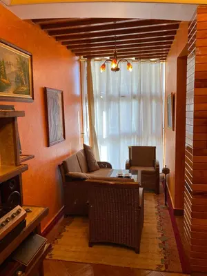 a living room with a couch and a table at Très joli appartement au centre de IFRANE in Ifrane
