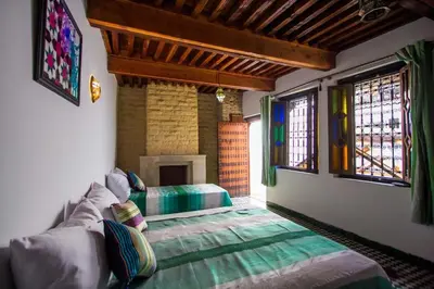 a living room with a couch and windows at dar Benfares rcif in Fès