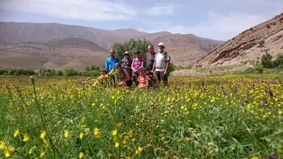 a group of people standing in a field of flowers at Gte Tawada - Valle Heureuse - Chambre pour 2 Personnes in Agouti