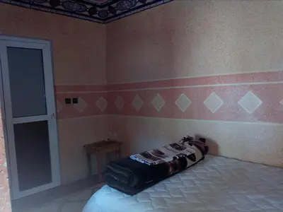 a bedroom with a bed with a pillow on it at Gte Tawada - Valle Heureuse - Chambre pour 2 Personnes in Agouti