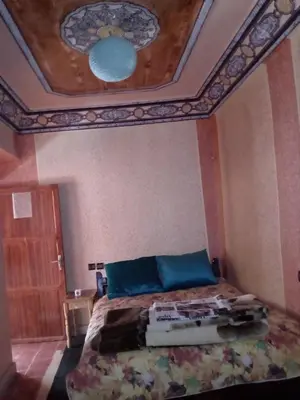 a bedroom with a bed with a coffered ceiling at Gte Tawada - Haut-atlas - Chambre pour 4 Personnes in Agouti
