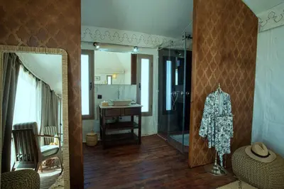 a bathroom with a glass shower and a mirror at Ghazala Camp - Luxury Erg Chigaga Magic in Mhamid