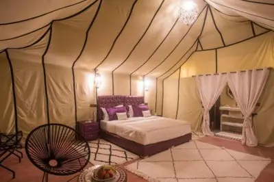 a bedroom with a bed in a tent at Sahara Events Camp in Merzouga