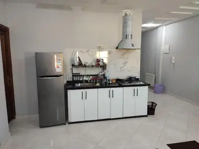 a kitchen with white cabinets and a refrigerator at The good stay 3 in Midelt