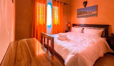 a bedroom with a bed with two towels on it at Hotel Rayyan l 'Escale in Ouarzazate