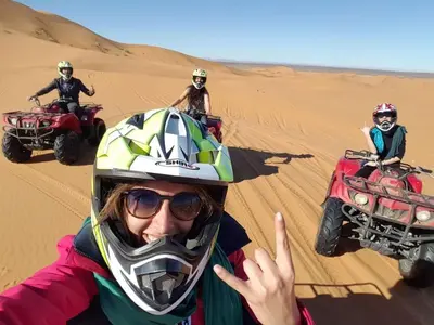 a group of people riding on atvs in the desert at Stargazing Merzouga Camp in Merzouga
